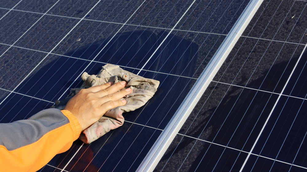 Hand,Cleaning,Solar,Panels.,A,Woman's,Hands,Use,A,Towel